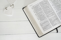 open Bible on a white table 