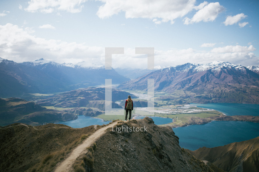 a woman standing on a mountaintop in New Zealand 