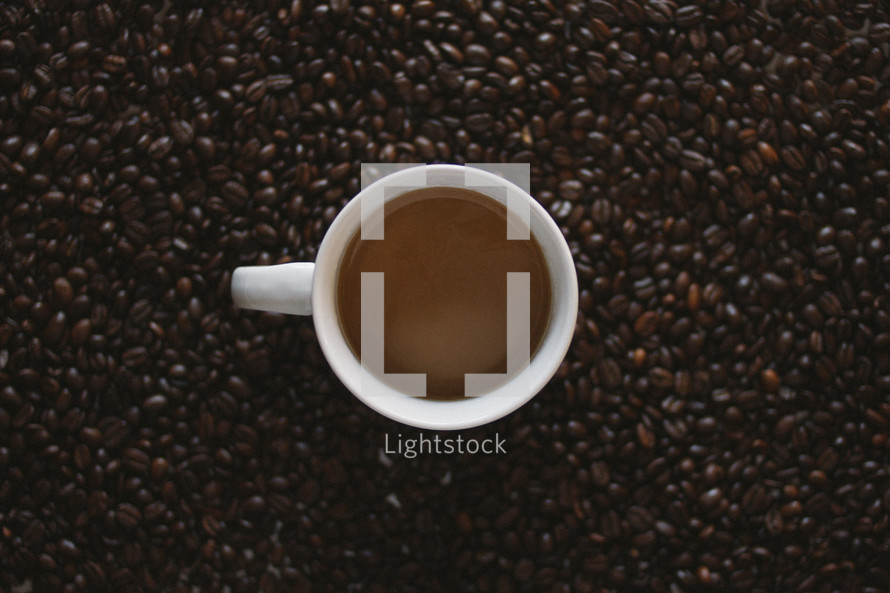coffee mug in a coffee bean background 