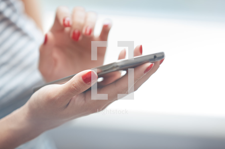 a woman touching a cellphone screen 