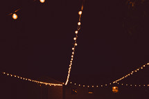 hanging strands of lights in a tent 