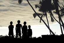 silhouette of kids and palm trees 