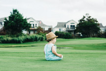 toddler boy on a golf course 