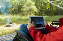 woman looking at an iPad screen outdoors 