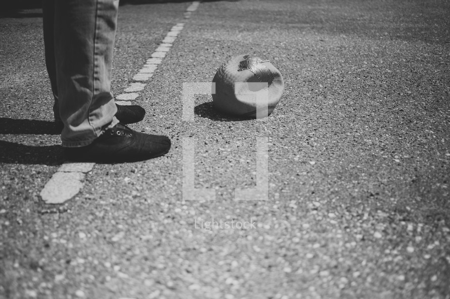 feet standing next to a deflated ball