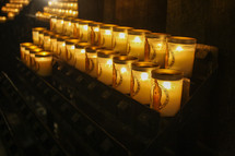 lighting prayer candles in a cathedral 