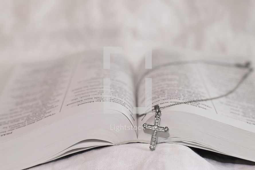 cross necklace on a Bible 