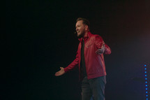 a pastor preaching on stage 
