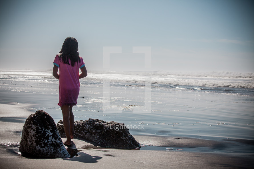 girl child standing on a beach 
