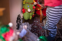 toddler playing with Christmas decorations 