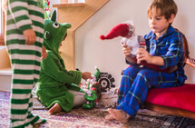 toddlers playing with Christmas decorations 