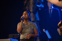 female singing into a microphone 