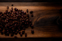 Coffee beans on wooden tabletop
