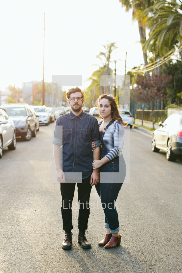 a couple standing in the middle of a LA street 