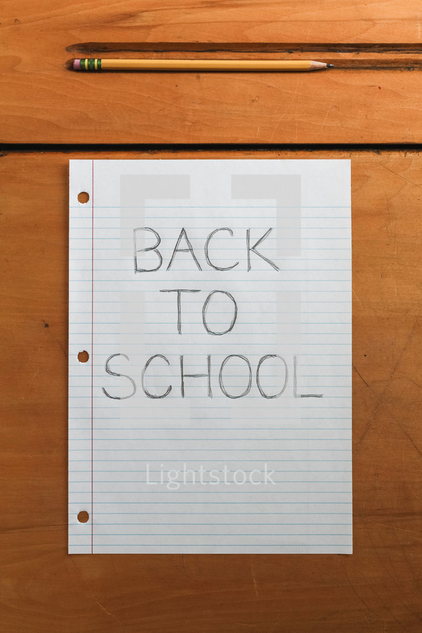 Back to School note and pencil on a desk
