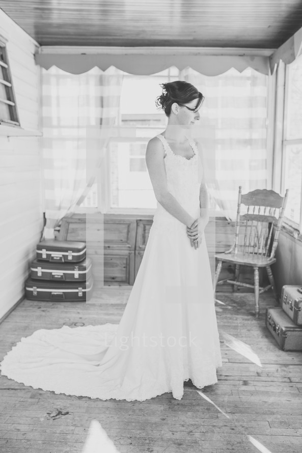 a bride standing in a wedding dress 