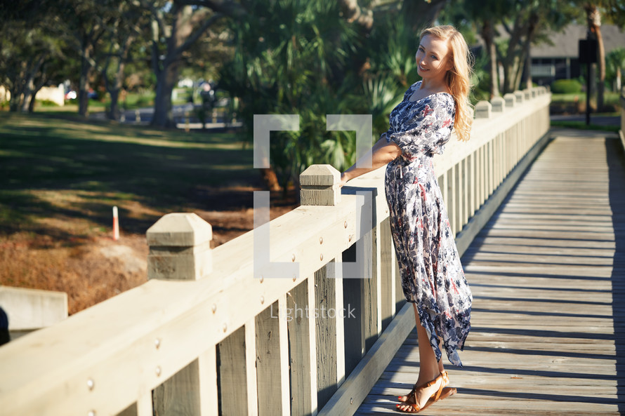 woman standing on a wooden bridge in Florida 