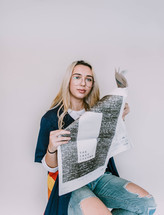 a young woman reading a newspaper 