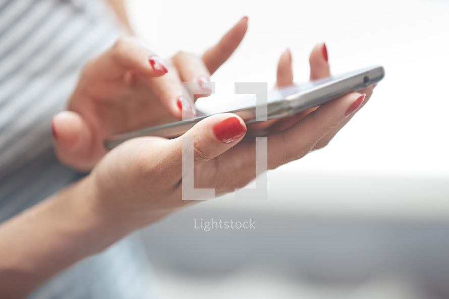 a woman touching a cellphone screen 