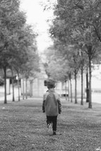 a boy walking in a park 