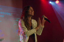 a worship musician singing on stage 