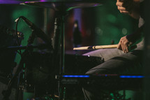 a man playing cymbals on stage 
