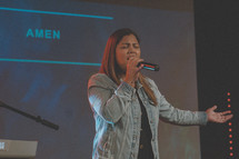 woman singing during a worship service 
