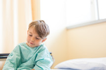 a boy child in a hospital gown 