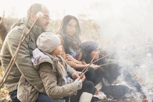 a family roasting marshmallows together 