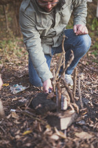 man building a campfire 
