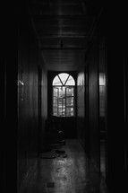 window at the end of a dark hallway 