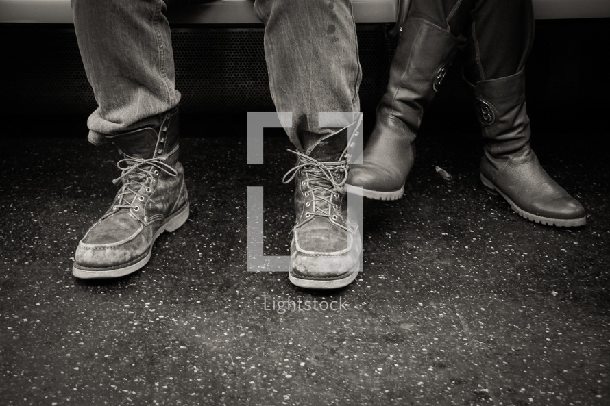 feet of a man and woman in boots 