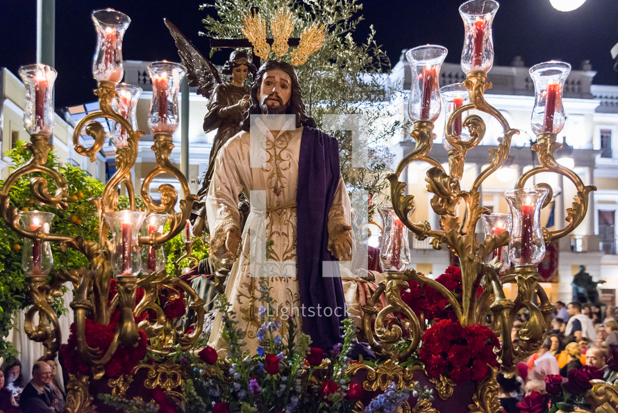 statue of Jesus surrounded by flowers 
