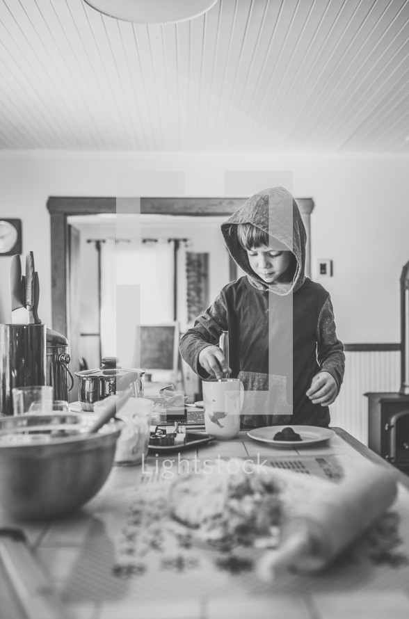 a boy in the kitchen and baking supplies 