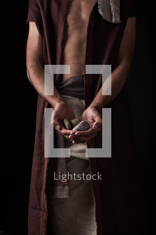 David with cupped hands holding stones 