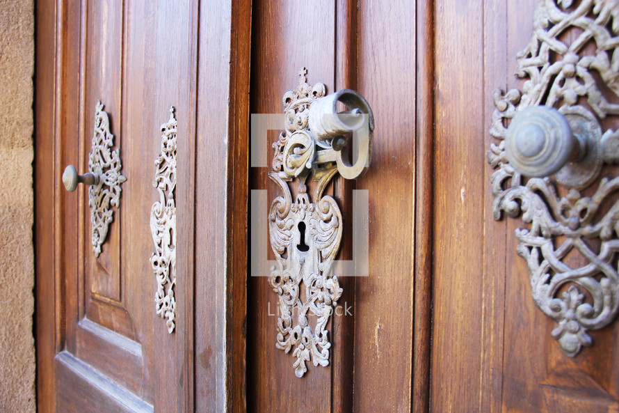ornate door knob on a wood door 