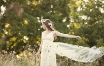 Bride standing in a meadow