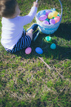 toddler boy playing with an Easter basket