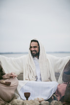Jesus sitting offering communion
