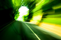 a blur of green light, moving, road, in motion, abstract 
