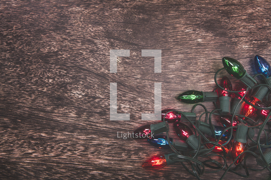 Christmas lights on a wood background 