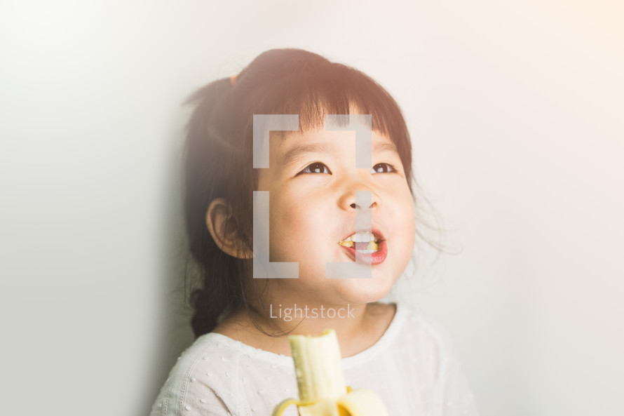 girl eating a banana 