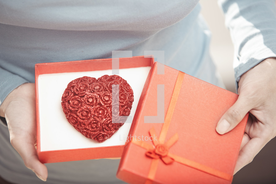 a heart cookie in a red gift box