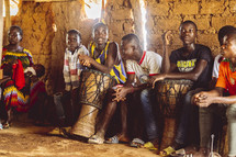 Christian African people playing drums, singing and dancing in a small village church in the Ivory Coast in west Africa