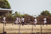 African men playing soccer football in a small village in the Ivory Coast in west Africa