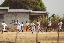 African men playing soccer football in a small village in the Ivory Coast in west Africa
