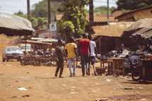 African men walking in a small village in the Ivory Coast in west Africa