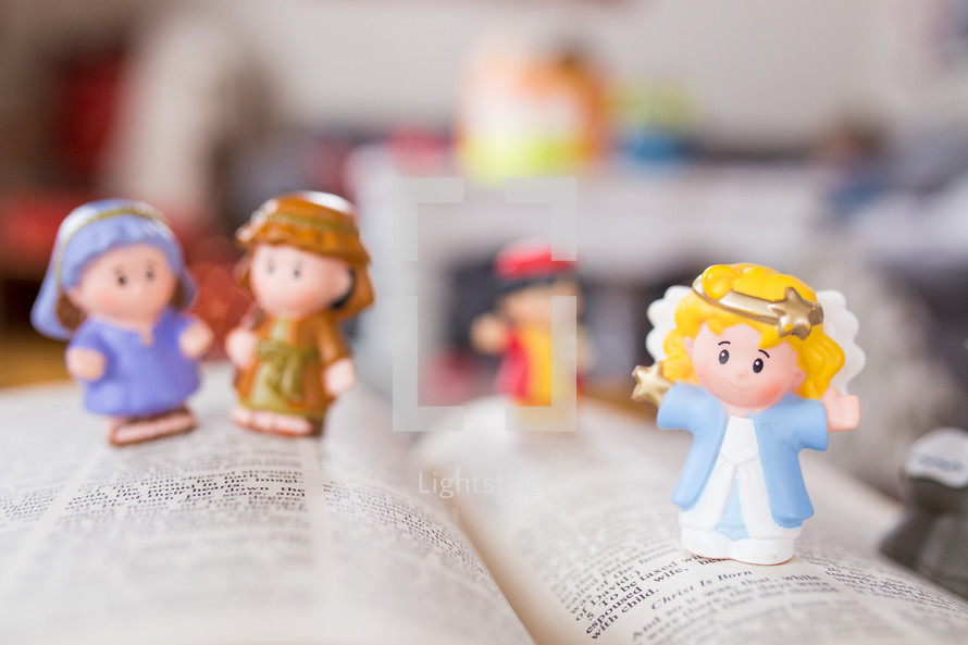 toy Bible figures on the pages of a Bible 