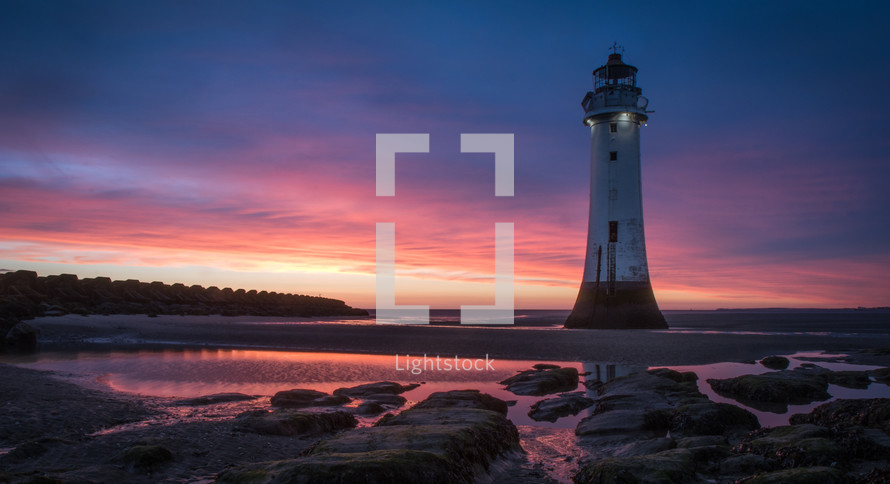 Glorious sunset behind lighthouse