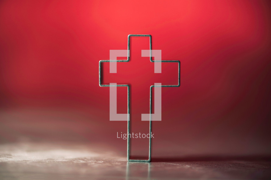 Silhouette of christian cross on soft lights background. Copy space. 